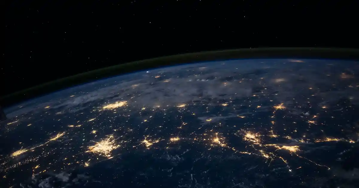 Earth from space, showing the lights from cities illuminating the night sky